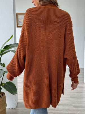 Ochre ribbed knit cardigan with pearl buttons and relaxed fit.