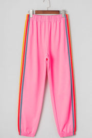 Pink track pants with rainbow side stripes