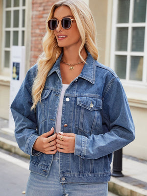 Medium wash denim jacket with button front and chest pockets, boxy fit