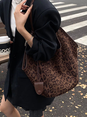 Chic leopard print tote bag in brown with leather trim and drawstring detail.