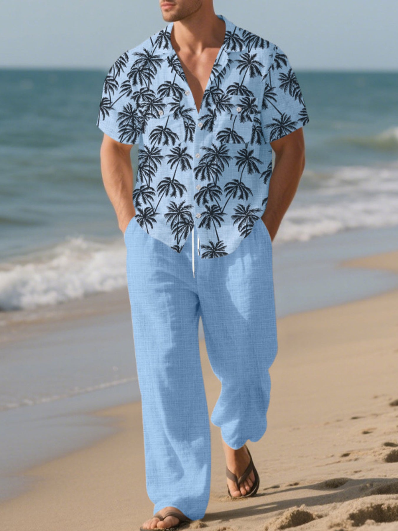 Men's pastel blue relaxed fit pants with drawstring waist, paired with a palm print short sleeve button-down shirt.