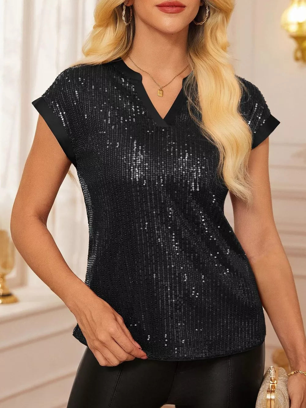 Black sequin cap sleeve blouse with V-neck and satin trim.