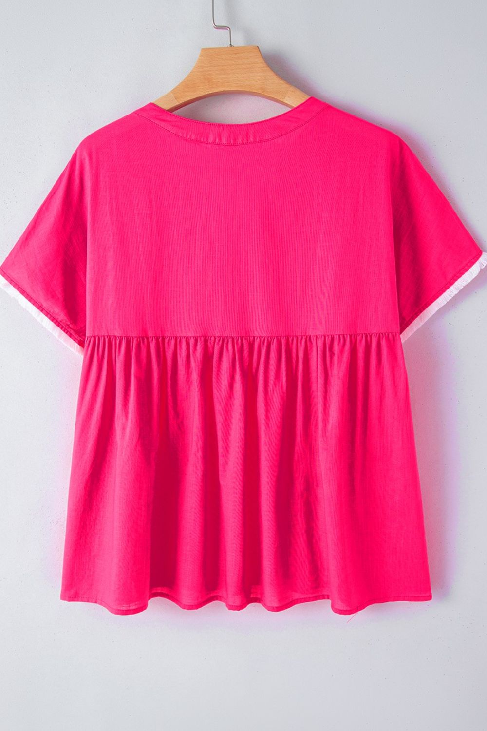 Strawberry pink babydoll blouse with white trim and gathered waist