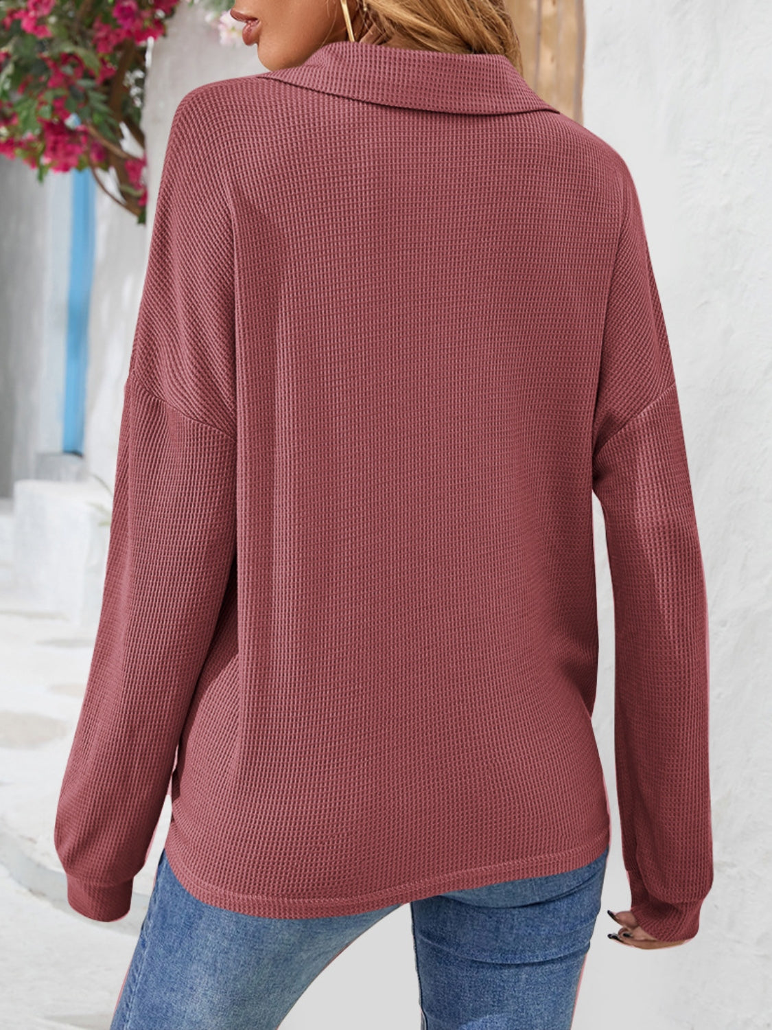 Waffle knit henley blouse in cerise with a collar and long sleeves.