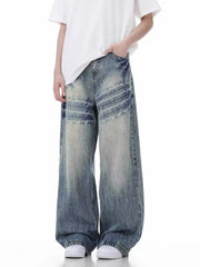 Distressed vintage wide-leg men's jeans in light blue denim with a relaxed fit.