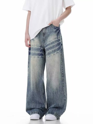 Distressed vintage wide-leg men's jeans in light blue denim with a relaxed fit.