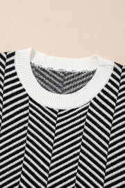 Black and white chevron knit crewneck sweater with white ribbed neckline.
