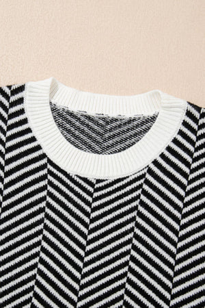 Black and white chevron knit crewneck sweater with white ribbed neckline.