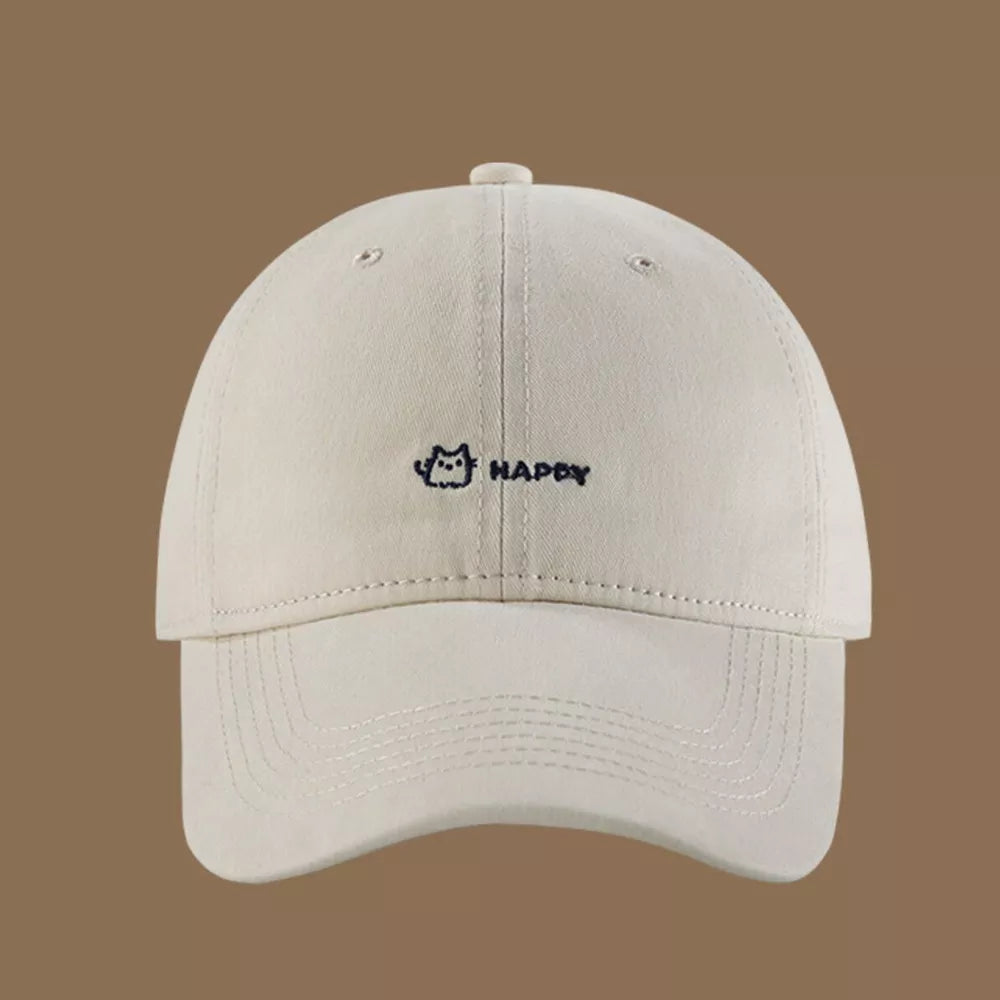 Cream white cotton baseball hat with embroidered cat and happy text.
