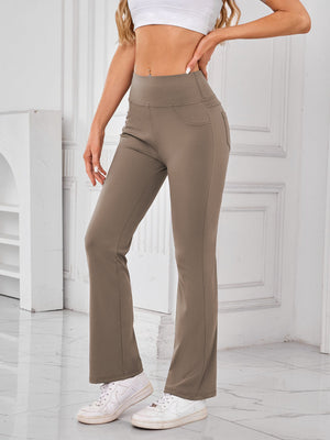 Camel flared activewear pants with pocket detail and wide waistband.