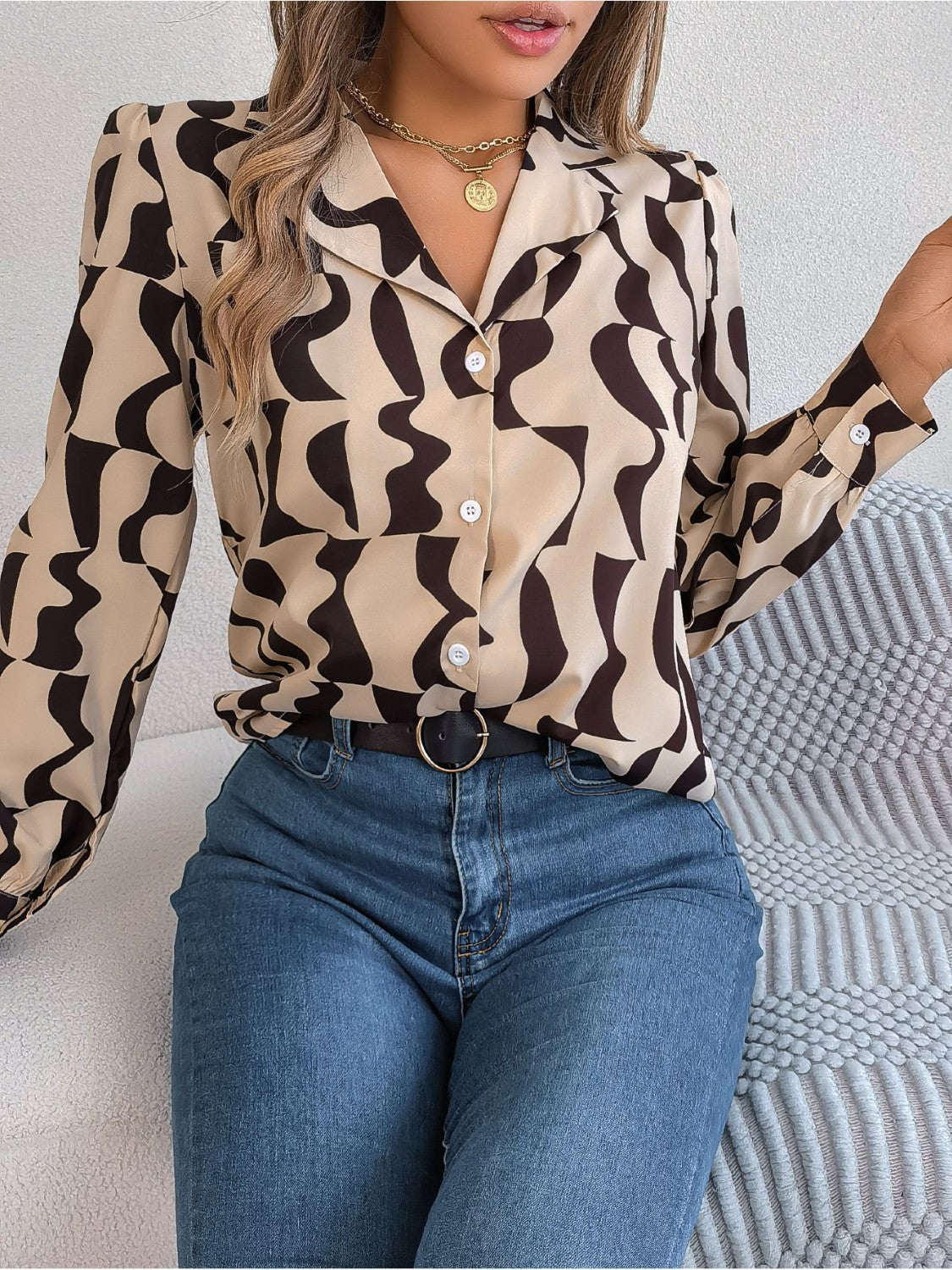 Camel abstract wave print silk-touch blouse with button front and collared neckline.