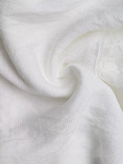 White smocked mini dress with eyelet hem detail