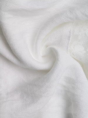 White smocked mini dress with eyelet hem detail