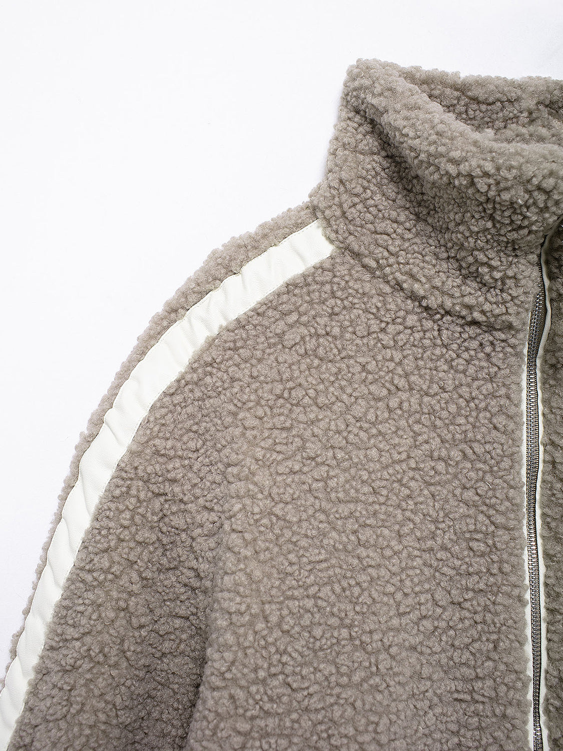 Dust Storm teddy fleece zip-up jacket with white contrast piping and high collar.
