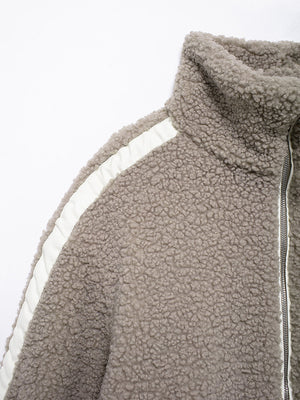 Dust Storm teddy fleece zip-up jacket with white contrast piping and high collar.