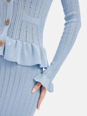 Light blue knit cardigan and skirt set with ruffled hem and bell sleeves.