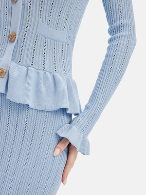 Light blue knit cardigan and skirt set with ruffled hem and bell sleeves.