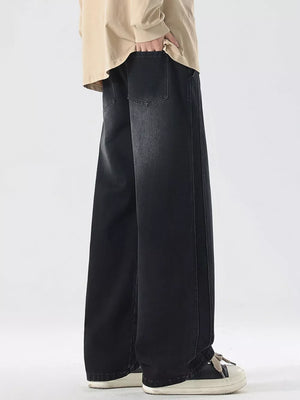 Oversized black washed denim jeans with drawstring waist and wide leg.