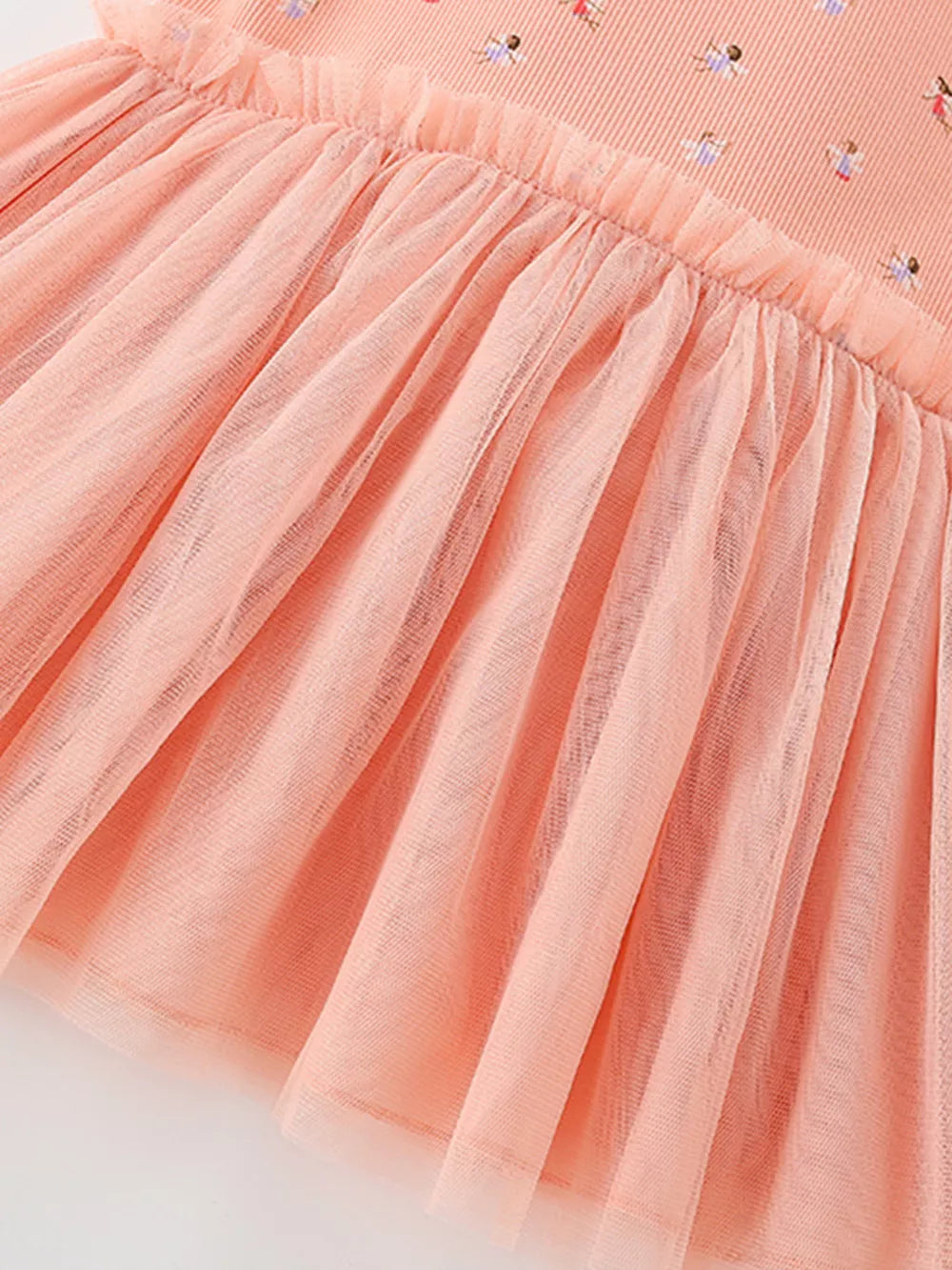 Peach tulle layered baby dress with a ruffled crew neck and dancer print.