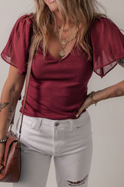 Burgundy ribbed knit top with flutter sleeves and v-neck.