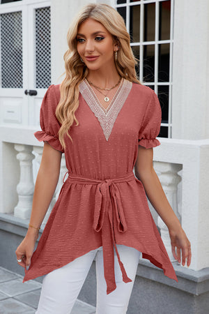 Dotted Swiss asymmetric hem blouse in watermelon pink with lace V-neck and tie waist