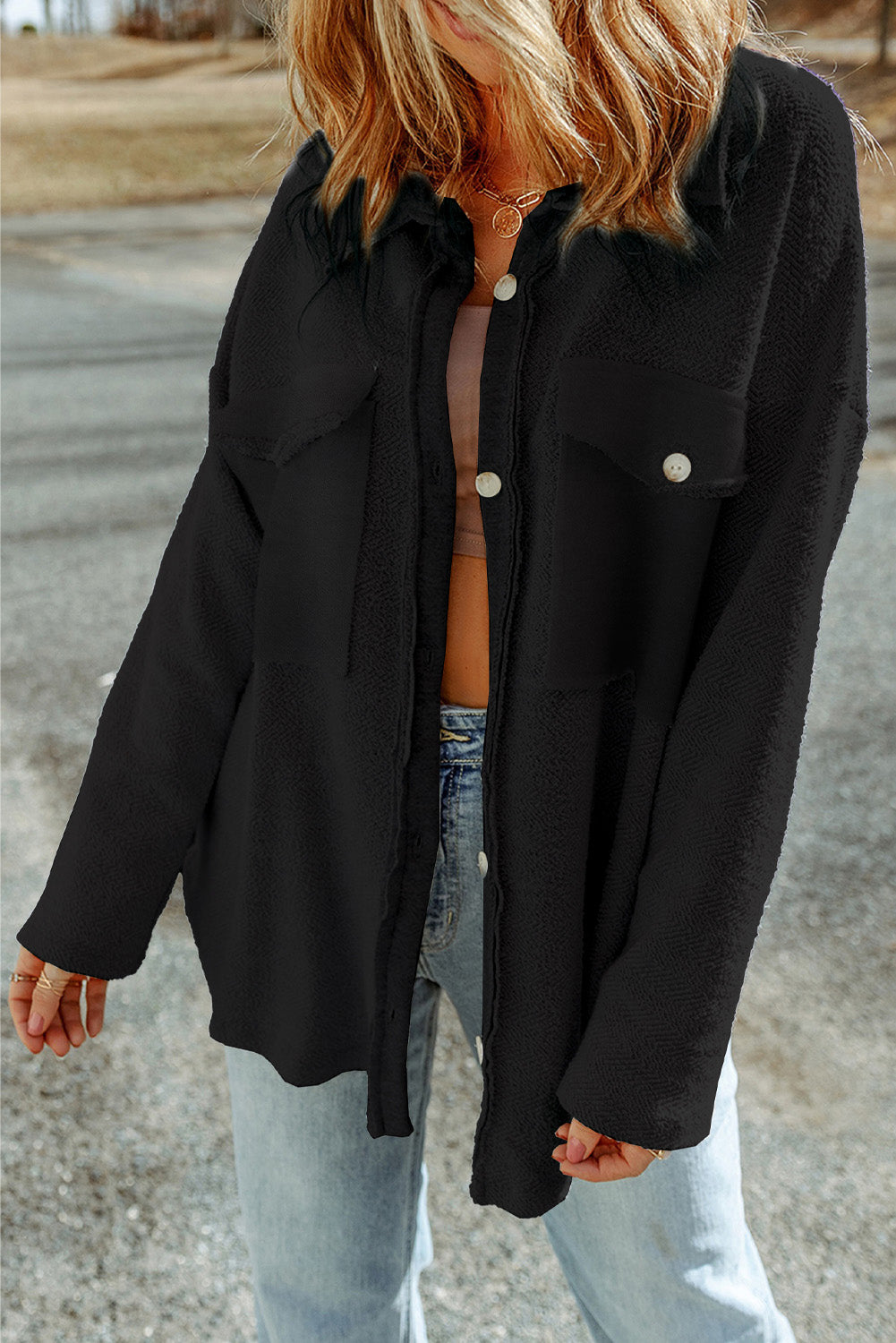 Black textured shacket with raw-edge detailing and button front.