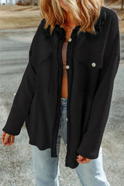Black textured shacket with raw-edge detailing and button front.