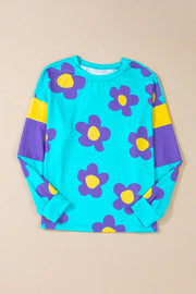 Daisy print crewneck top in pastel blue with purple and yellow colorblock sleeves.