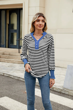 Striped long sleeve blouse with blue neckline and cuffs, henley detail