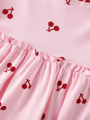 Children's pink short sleeve dress with allover cherry print and ruffled hem.