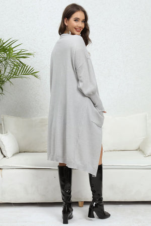 Light gray oversized pocketed knit cardigan with long sleeves and a relaxed fit.