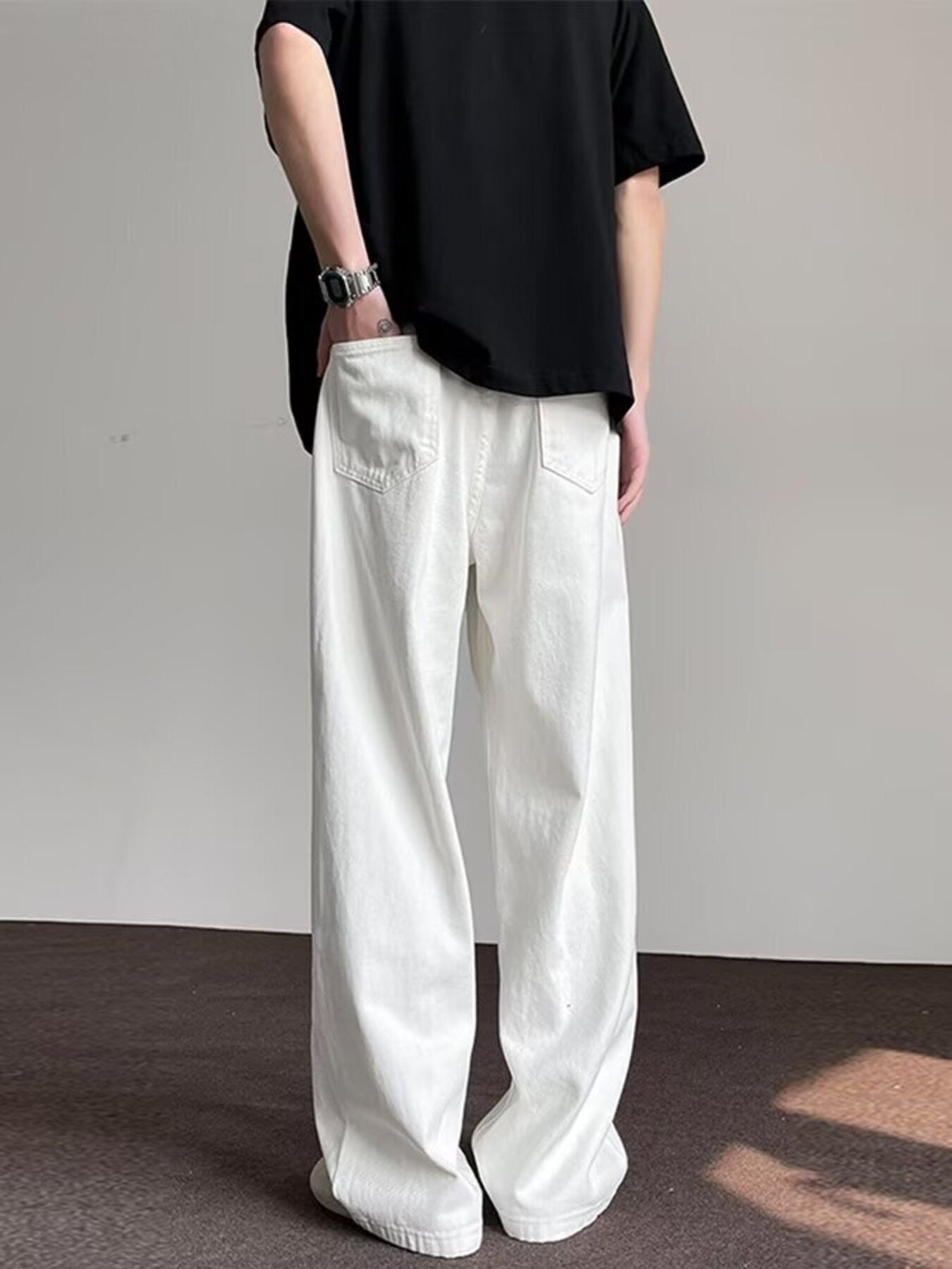 Men's white wide-leg jeans with a relaxed fit and classic back pockets.