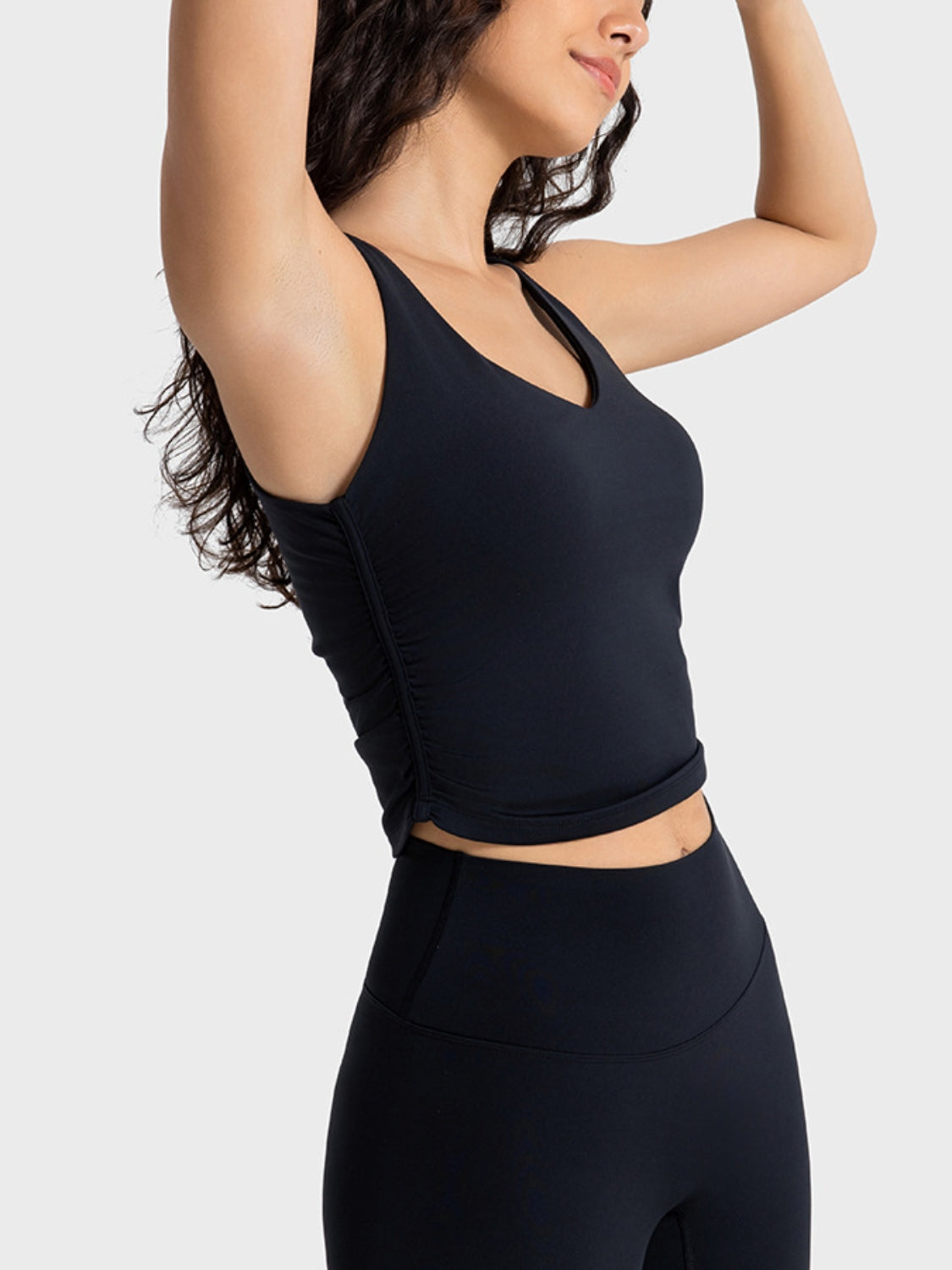 Black sculpted ruched tank top with V-neck and athletic fit.