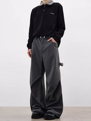 Men's grey pinstripe wide-leg sweatpants with pockets and a relaxed fit.