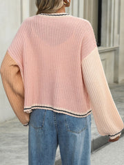 Colorblock trim knit cardigan in pink and peach acrylic with striped neckline and hem.
