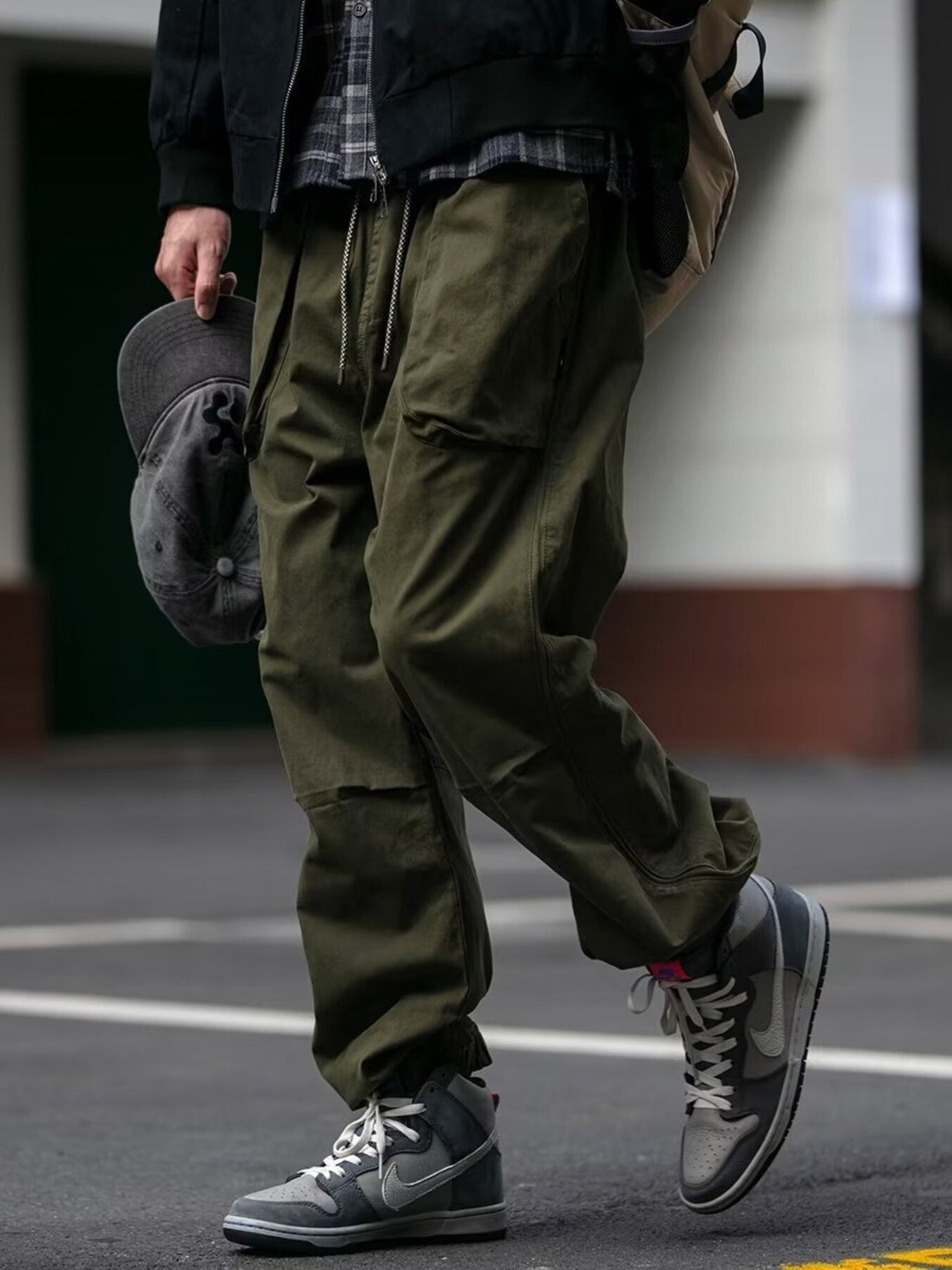 Men's army green drawstring sweatpants with multiple pockets and a relaxed fit.