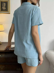 Sky blue cotton button-up shirt and shorts set with collared neckline and short sleeves.