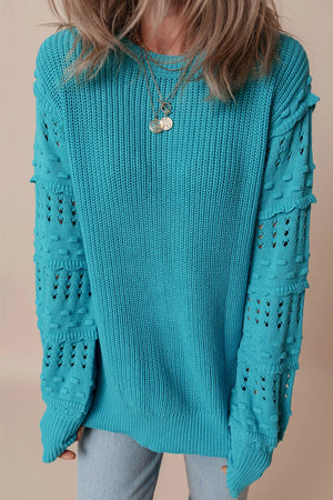 Turquoise knit sweater with textured cutout sleeves and crew neck.