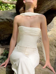 Cream ruched tube top with sheer scarf detail, paired with white pants.