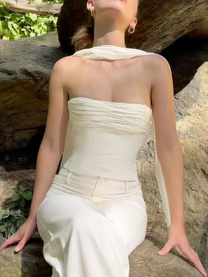 Cream ruched tube top with sheer scarf detail, paired with white pants.