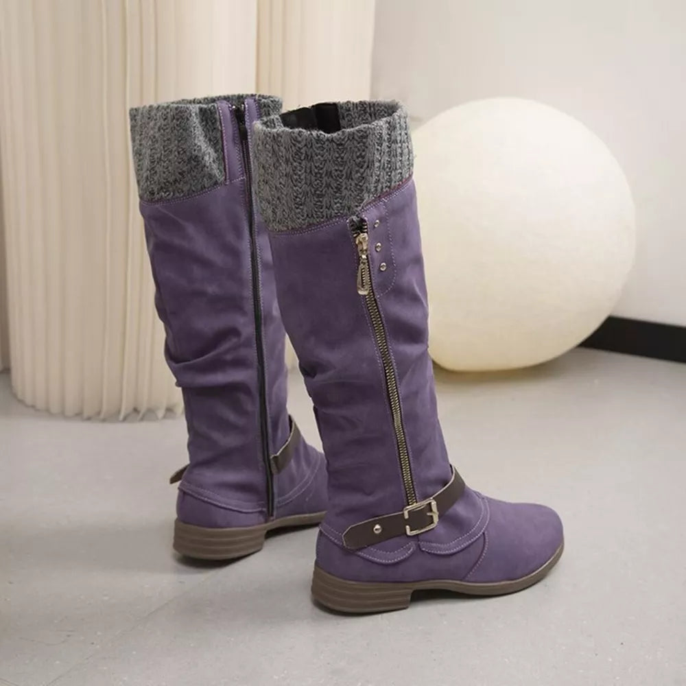 Purple suede knee-high slouch boots with grey knit detail and side zipper.