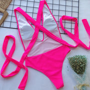 Hot Pink wrap-around halterneck plunge swimsuit with crisscross straps and a high-cut leg.