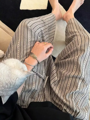 Men's wide-leg sweatpants with vertical stripes and dotted accents, featuring a drawstring waist.