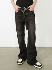 Faded flare jeans in dark distressed wash denim with a buttoned closure and belt.