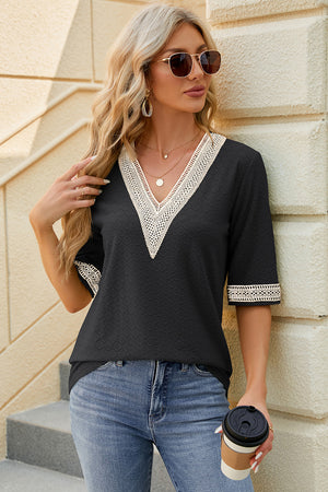 Black textured v-neck blouse with lace trim on neckline and sleeves