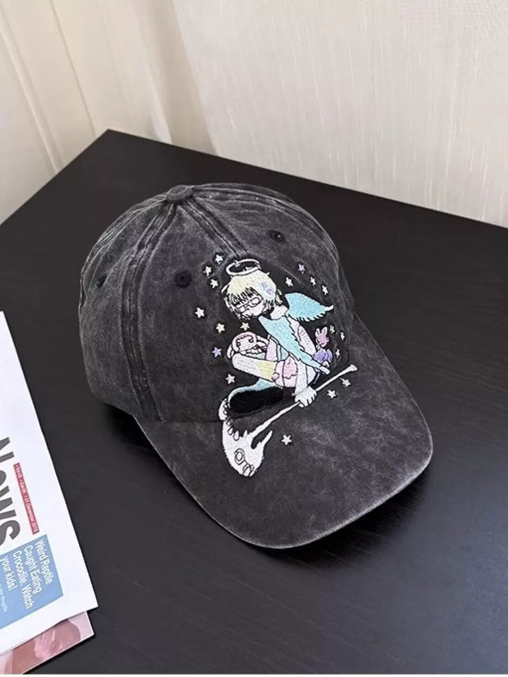 Black cotton baseball cap with whimsical angel embroidery and stars