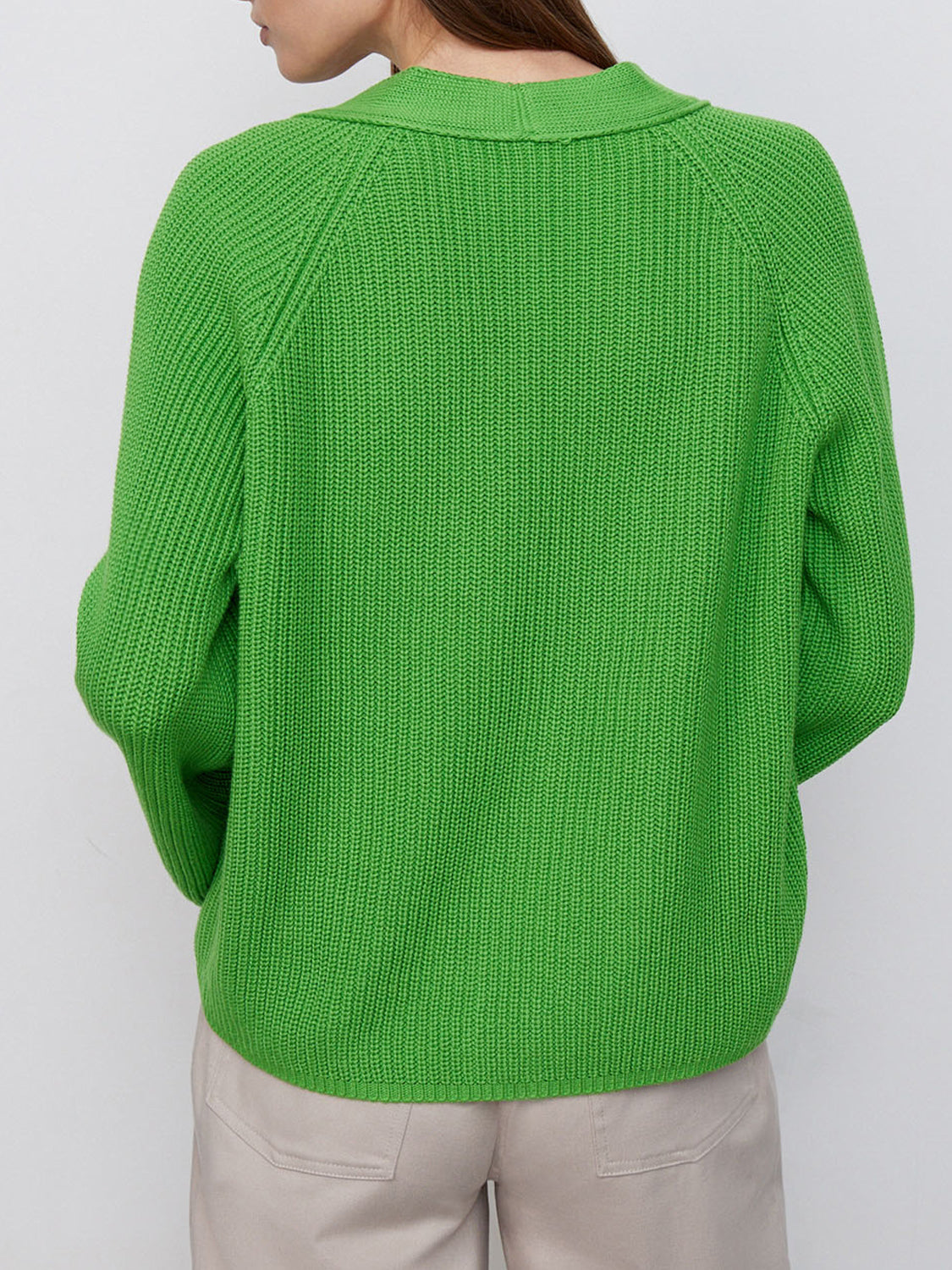 Green ribbed raglan cardigan with deep V-neck and button detail.