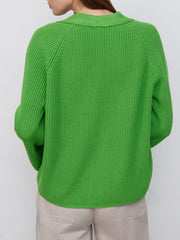 Green ribbed raglan cardigan with deep V-neck and button detail.