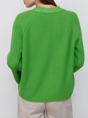 Green ribbed raglan cardigan with deep V-neck and button detail.