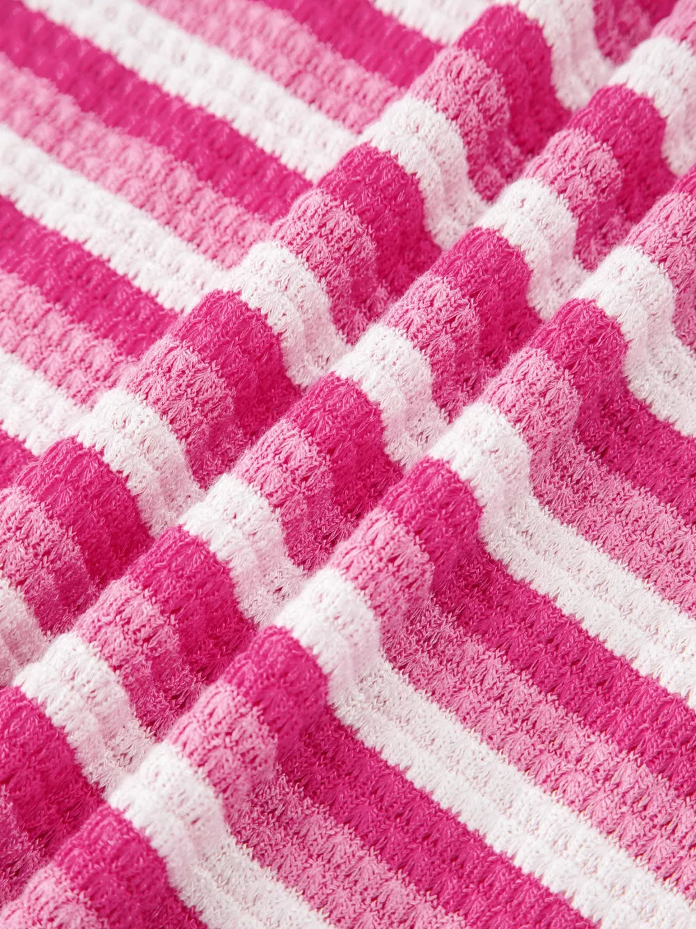 Textured knit tee with pink and white stripes and crossed detail.